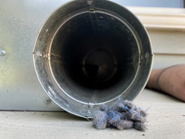 Commerce Dryer Vent Cleaning technician using specialized equipment to clear severe dryer vent blockage in Commerce